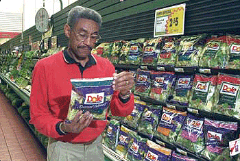 Man in store reading a salad bag