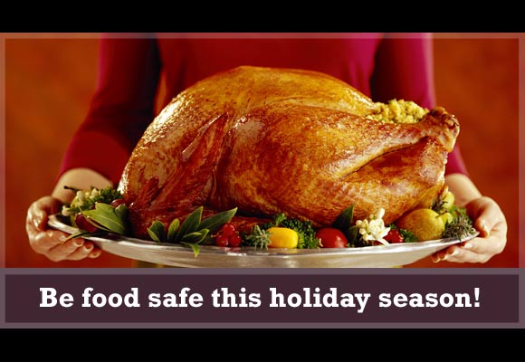 This card shows a person holding a fully cooked turkey on a serving platter and it says, 