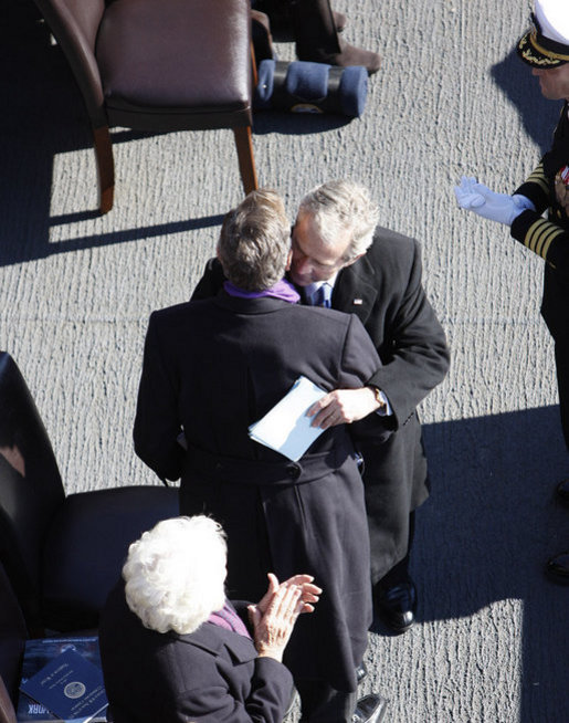 President George W. Bush embraces his father, former President George H. W. Bush, following his remarks honoring his father during the commissioning ceremony of the USS George H. W. Bush (CVN 77) aircraft carrier Saturday, Jan 10, 2009 in Norfolk, Va. White House photo by Eric Draper