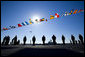 U.S. Navy Sailors line the deck of the the USS George H.W. Bush (CVN 77) aircraft carrier as a World War II Avenger Torpedo bomber similar to the plane flown by former President George H.W. Bush does a flyby Saturday, Jan. 10, 2009, during commissioning ceremonies in Norfolk, Va. White House photo by David Bohrer