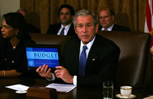 President Bush holds up a computer with his E-Budget for the cameras during a Cabinet meeting Monday, Feb. 4, 2008.
