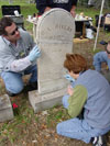 Myles Bland and Debbie Smith apply a fill patch to a repaired stone. (Jason Church)