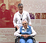 World War II factory worker Thelma Snyder poses with her daughter, Linda Denney, in front of one of the National Women's History Museum exhibits at the Women in Military Service to America Memorial in Arlington, Va. Photo by Rudi Williams