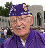 Robert Dornblaser of Lander, Wyo., in his Purple Heart hat and jacket, reflects on his service with the National Guard's 32nd Infantry Division in the Pacific Theater the Sunday after the National World War II Memorial was dedicated in Washington on May 29. 
