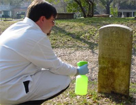 Jason Church cleans headstone