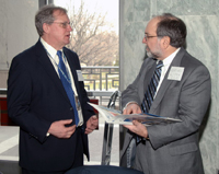 Hershel Lipow, a member of OCC's Community Affairs team, discusses the OCC's www.HelpWithMyBank.gov Web site and consumer complaint process with an attendee during the NCPW event.