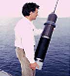 A scientist is ready to deploy an  instrument in the ocean