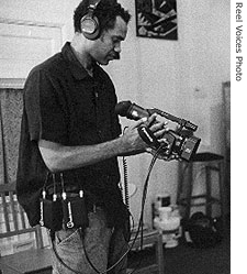 Eritrean American filmmaker Filmon Mebrahtu with camera in hand in a detail from a production still