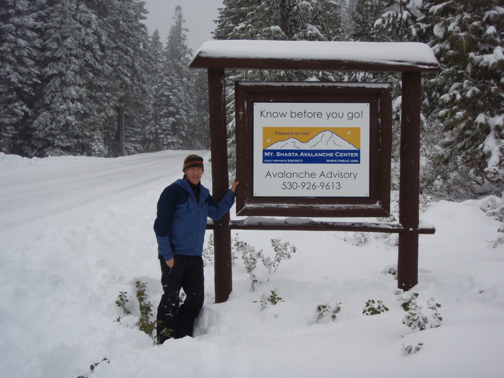 Photo of FMSAC board member Keith Potts next to the newly installed "Know Before You Go" sign on the Everitt Memorial Highway, Mt. Shasta, 12/28/08
