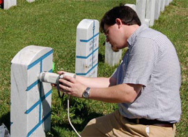 Jason Church positions the head of the Minolta colorimeter for measurements on a
headstone in Alexandria National Cemetery.