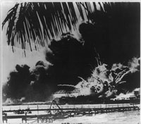Pearl Harbor naval base aflame after the Japanese attack