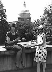 Photo:  two women - one is holding an egg, and one is holding a frying pan, with  U.S. Capitol in the background.