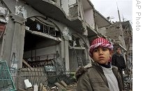 A Palestinian boy stands next to destroyed houses after an Israeli missile strike in the Rafah refugee camp, southern Gaza Strip, Thursday, 01 Jan. 2009