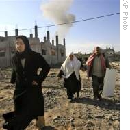 Palestinians run from the area during an Israeli airstrike in Rafah, southern Gaza Strip, 12 Jan 2009