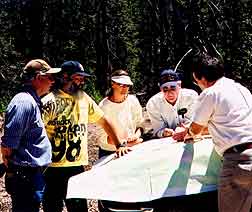 Consulting parties looking at map at Medicine Lake Highlands, California