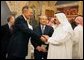 Former President George H.W. Bush, left, shake hands with newly crowned King Abdullah, right, during a retreat at King Abdullah's Farm in Riyadh, Saudi Arabia Friday, August 5, 2005, following the death of his half-brother King Fahd who passed away August 1, 2005. Interpreter Gamal Helal, center, is also pictured. White House photo by David Bohrer