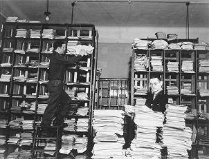 American army staffers organize stacks of captured German documents.