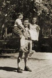 Albanian rescuer Refik Veseli holding the Jewish children he sheltered during the war.