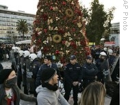 Protesters peacefully dance in a circle around police officers, some in riot gear, protecting the Christmas tree during a protest in central Athens' Syntagma Square, Greece, 20 Dec 2008