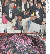 Supporters of Pakistan's slain former Prime Minister Benazir Bhutto mourn at her grave in Garhi Khuda Bakhsh, 27 Dec 2008