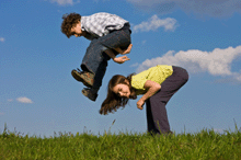 a photo of a boy and a girl playing leap frog.