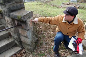 Jason Church examines concrete retaining wall
