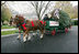 Scott D. Harmon of Brandy Station, Va., drives a horse-drawn carriage delivering the official White House Christmas tree Monday, Nov. 26, 2007, to the North Portico of the White House. The 18-foot Fraser Fir tree, from the Mistletoe Meadows tree farm in Laurel Springs, N.C., will be on display in the Blue Room of the White House for the 2007 Christmas season.