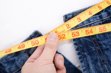 a photo of a person taking a waist measurement.