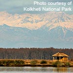 Kolkheti National Park: Ranger shelter on Paliastomi Lake with the Caucasian mountain range in the background.