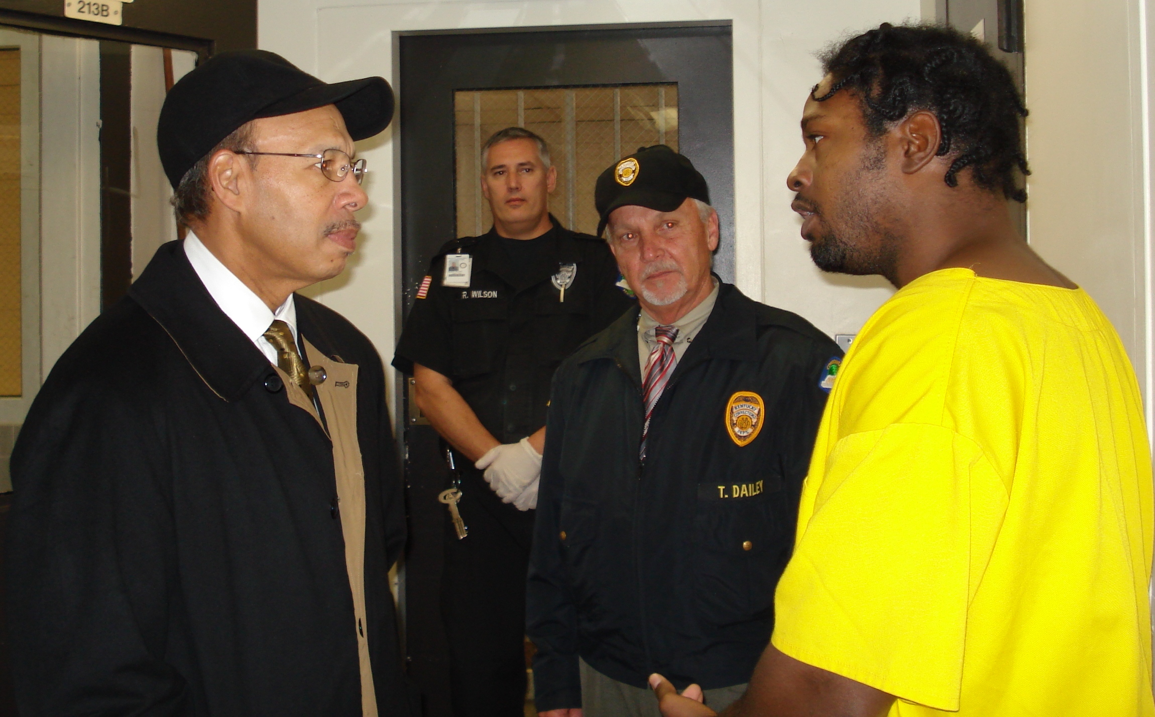 Secretary Brown talks with Warden Dailey and inmate Crawford