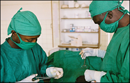Two surgeons operate on a patient in the Democratic Republic of the Congo.