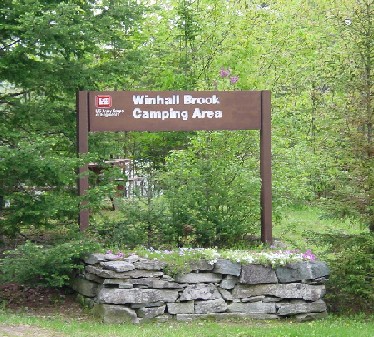 Looking at the brown sign at the entrance to Winhall Brook Camping Area.