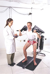 Woman monitoring man who is using excersize machine.