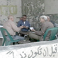 Old men of Jalazone refugee camp play card games to past time