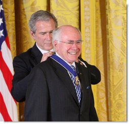 Former Prime Minister John Howard of Australia, smiles as President George W. Bush presents him with the 2009 Presidential Medal of Freedom Tuesday, Jan. 13, 2009, during ceremonies in the East Room of the White House. Established in 1963, the Medal may be presented to "any person who has made an especially meritorious contribution to the security or national interests of the United States, or world peace or cultural or other significant public or private endeavors." White House photo by Chris Greenberg