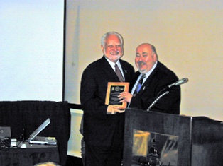 Commissioner Joseph Doria, right, presents East Orange Mayor Robert L. Bower with an Outstanding Achievement Award at the Lead Interventions for Children-at-Risk recognition luncheon on September 29, 2008.