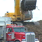 An on-going effort with heavy equipment is necessary to clear away the storm debris