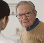 Photo: An older man consulting a healthcare professional