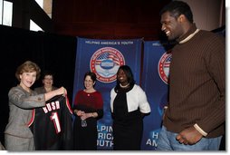 Mrs. Laura Bush holds an National Basketball Association basketball jersey presented to her by NBA player Mr. Greg Oden of the Portland Trail Blazers, during the regional conference on Helping America's Youth at the Portland Center for the Performing Arts in Portland, Ore. Also attending the presentation are, from left, Ms. Robyn Williams, executive director, Portland Center for the Performing Arts; Mrs. Mary Oberst, first lady of Oregon; and student, Ms. Shantel Monk. White House photo by Shealah Craighead