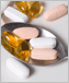 Photo of multiple vitamin pills and spoon.