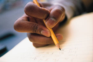 Photo of child writing with a pencil