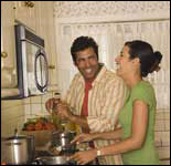 Photo: A man and woman cooking