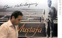 Man walks by poster advertising documentary 'Mustafa' in Istanbul