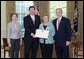 President George W. Bush and Mrs. Bush present the Preserve America award for heritage tourism to Dennis Castleman, Assistant Secretary for Tourism, Film, and the Arts, Maryland Department of Business and Economic Development, and Audrey Scott, Secretary of Planning, Maryland Department of Planning, in the Oval Office Monday, May 1, 2006. White House photo by Eric Draper