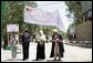 Mrs. Laura Bush, left, assists local officials with the ribbon cutting ceremony June 8, 2008 in Afghanistan at the ground-breaking ceremonies for the 1.96 kilometer Bamiyan road project through the bazaar. The new road will link up with a 1.72 kilometer road from the airport to the town center completed in 2007 with U.S. support. White House photo by Shealah Craighead