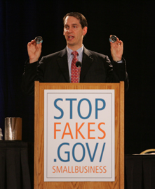 Deputy Under Secretary of Commerce for IP Steve Pinkos shows a Texas small business audience nearly identical real and fake boat gauges in Austin, Texas on Sep. 12, 2005