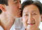 asian man kissing mother on head