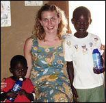Photo: Amy Parker with Kenyan children holding bottles of the chlorine disinfectant used to treat drinking water.