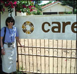 Photo: Pat Riley in front of a CARE sign; CDC collaborated with CARE-Kenya on the project.