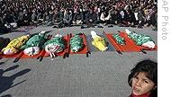 Palestinians pray over the bodies of seven members of one family  killed in an Israeli airstrike on their house in the Jebaliya refugee camp, Gaza 09 Jan 2009